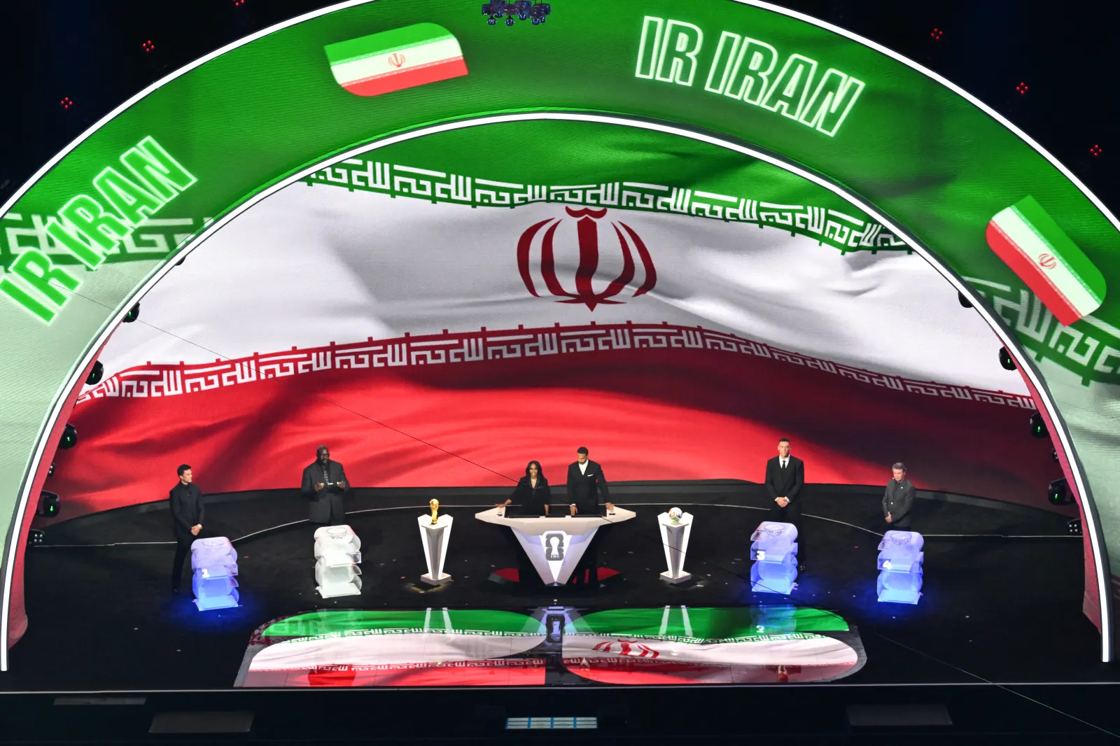 The Iranian flag is displayed on a screen during the draw for the 2026 FIFA Football World Cup at the Kennedy Center in Washington on December 5, 2025. (Photo by Roberto SCHMIDT / AFP via Getty Images)