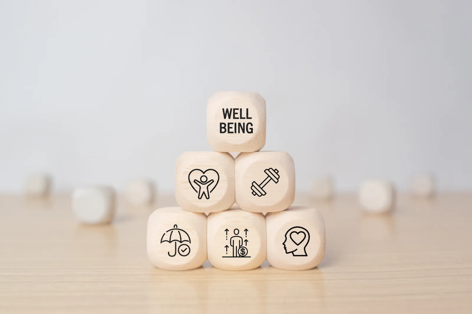 Wooden blocks with physical, mental, emotional health icons.