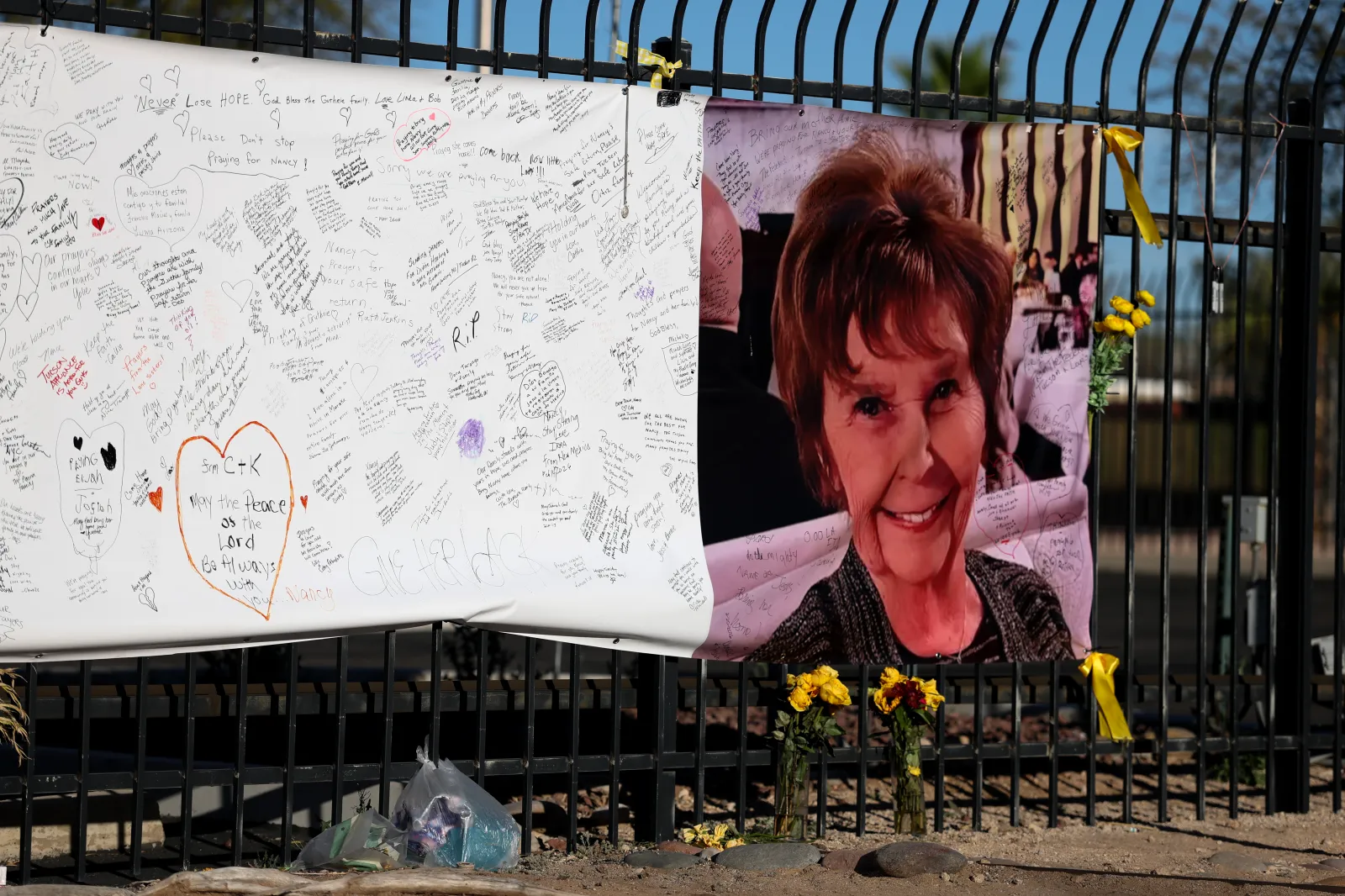 A photograph of Nancy Guthrie is seen on a sign that people can leave messages on February 26, 2026, in Tucson, Arizona.