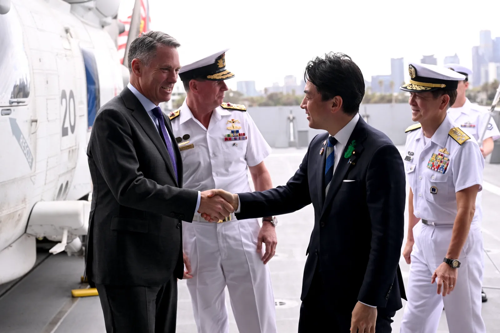 Australian Deputy Prime Minister and Minister Richard Marles (L) shakes hands with Japanese Minister of Defense Koizumi Shinjiro (R) in Melbourne after the signing of the contract for Japan to deliver the first three of Mogami-class warships, on April 18, 2026.