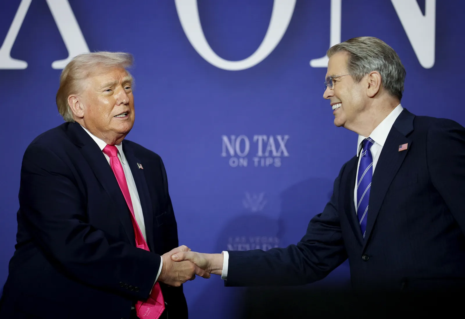 President Donald Trump (L) shakes hands with Treasury Secretary Scott Bessent at an event in Las Vegas, Nevada, on April 16, 2026.