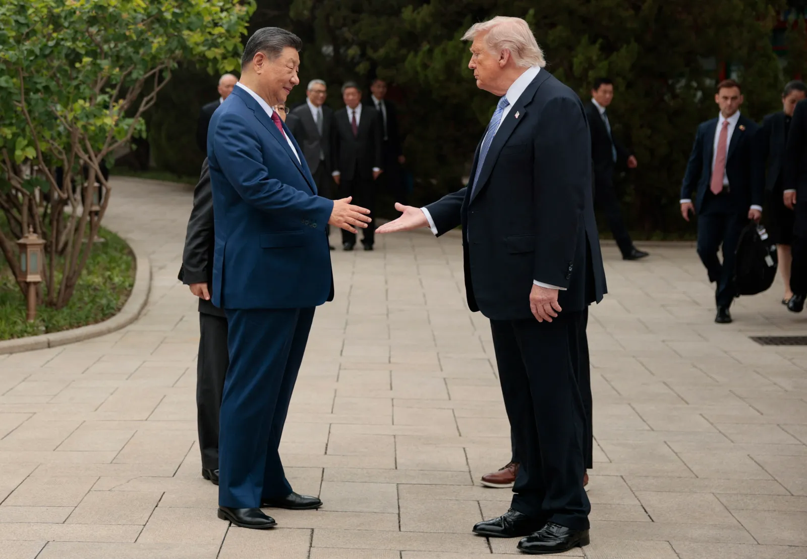 U.S. President Donald Trump (R) shakes hands with Chinese President Xi Jinping in Beijing on May 15, 2026.