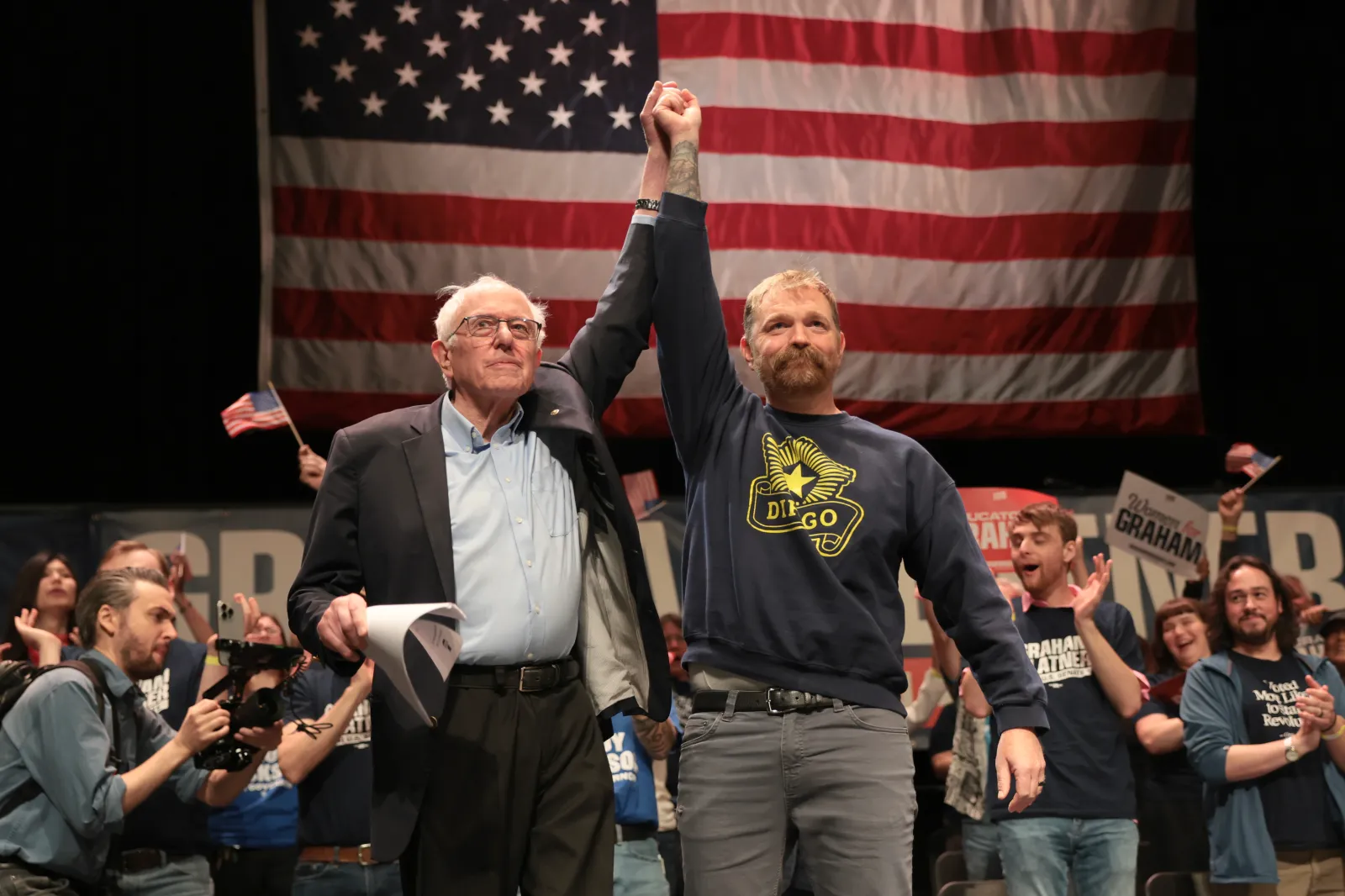 Sen. Bernie Sanders (I-VT) and Democratic U.S. Senate candidate Graham Platner stand together during a “Fighting Oligarchy” tour stop at the Collins Center for the Arts on the University of Maine campus on May 24, 2026 in Orono, Maine. Platner is the presumptive Democratic nominee and will face incumbent Sen. Susan Collins (R-ME) for Maine's U.S. Senate seat in the general election. (Photo by Joe Raedle/Getty Images)