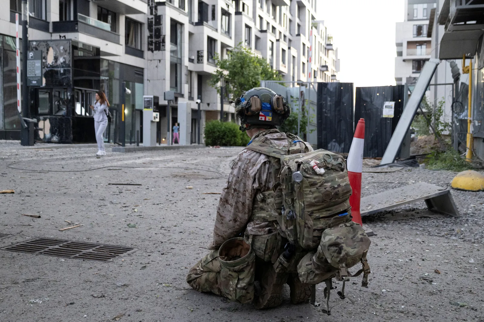 A Ukrainian serviceman kneels in front of a damaged residential building following an air attack in Kyiv on June 2, 2026, amid the Russian invasion of Ukraine. (Photo by Serhii Okunev / AFP via Getty Images)