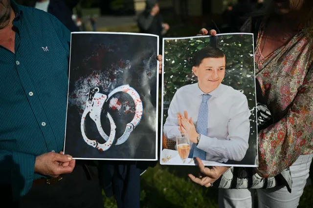 People hold images of victim Henry Nowak, and blood-covered handcuffs as they take part in a protest outside of Southampton Central Police Station in Southampton, England, on June 2, 2026, following the killing of Nowak by Vickrum Digwa.