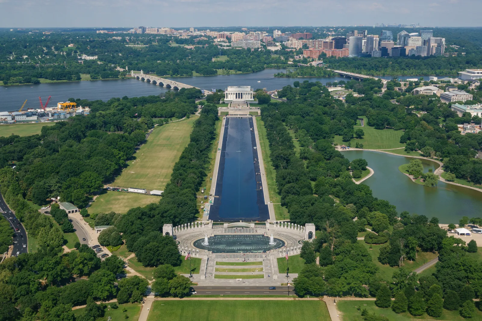 People gather at the World War II Memorial as the Lincoln Memorial Reflecting Pool is refilled after it was recently resurfaced on June 7, 2026, in Washington, D.C.