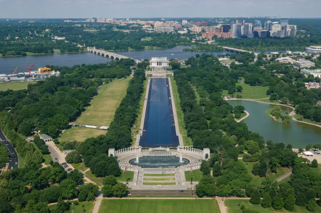 People gather at the World War II Memorial as the Lincoln Memorial Reflecting Pool is refilled after it was recently resurfaced on June 7, 2026, in Washington, D.C.
