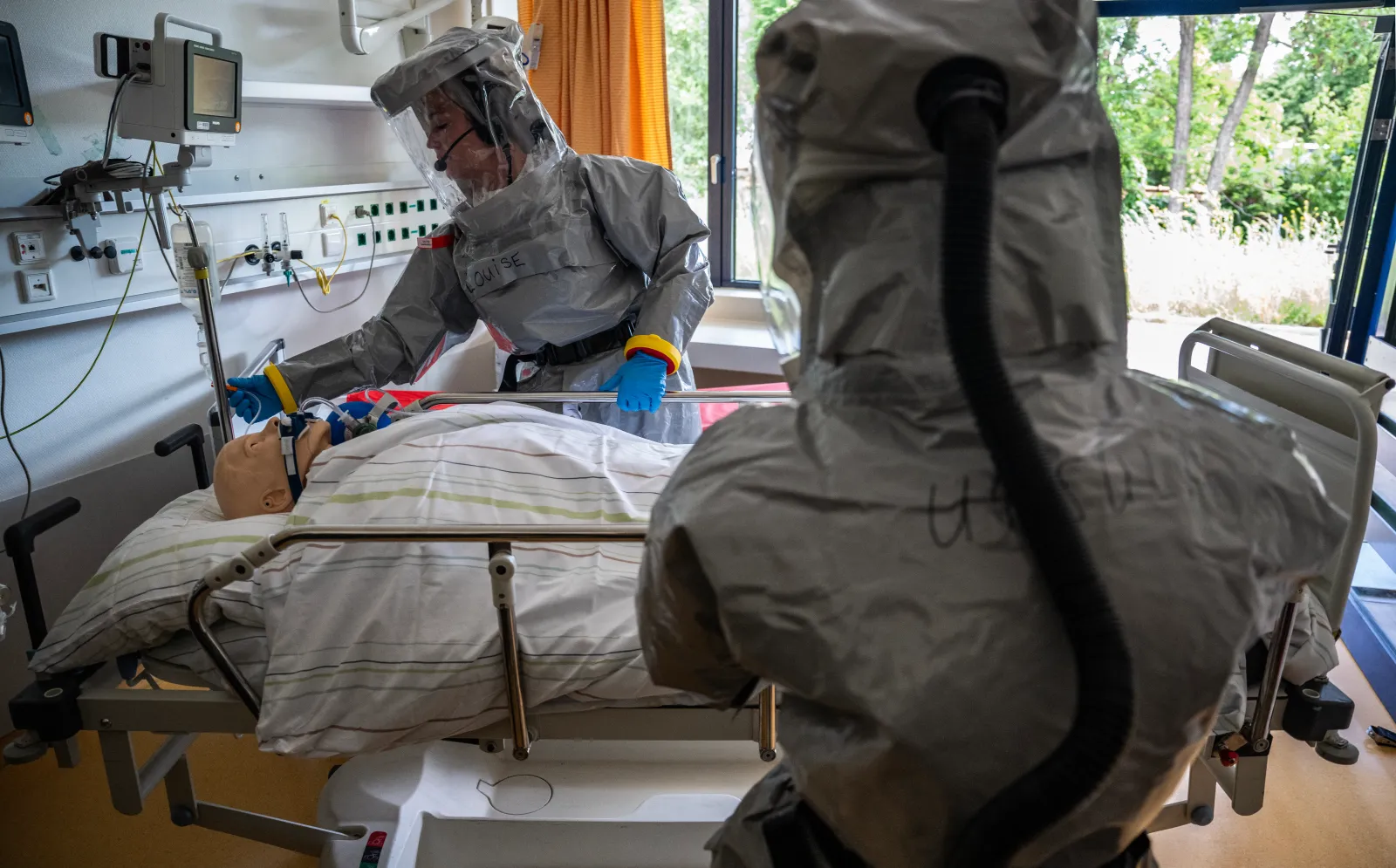 Two nurses in their PPE (Personal Protection Equipment) install a patient with a highly infectious disease, such as Ebola, during a simulation at the special isolation ward of the Department of Infectious Diseases at the Charite Virchow hospital in Berlin on June 9, 2026.