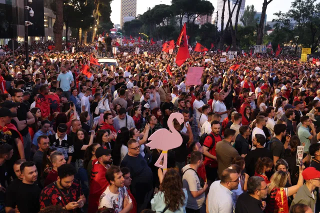 Protesters hold national flags as they gather in front of Albania's Prime Minister's Office in Tirana, on June 13, 2026 during a demonstration against the construction of a luxury resort near a protected natural area of Zvernec near Vlore linked to the U.S. president's son-in-law, Jared Kushner.