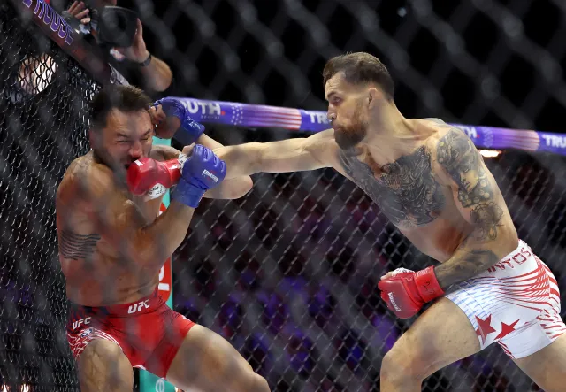 UFC fighter Mauricio Ruffy of Brazil connects on a punch to American fighter Michael Chandler at UFC Freedom 250