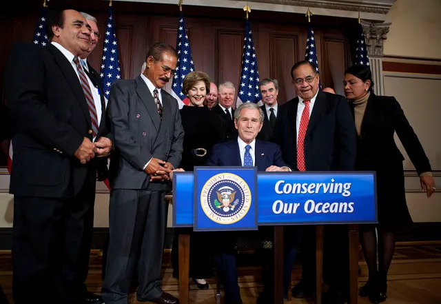 U.S. President George W. Bush signs a proclamation establishing the Marianas Trench Marine National Monument at the Eisenhower Executive Office Building, January 6, 2009, in Washington, D.C. The proclamation will protect 195,274 square miles around the Mariana Trench and will reportedly be the largest marine conservation effort on record. (Photo Joshua Roberts-Pool/Getty Images)