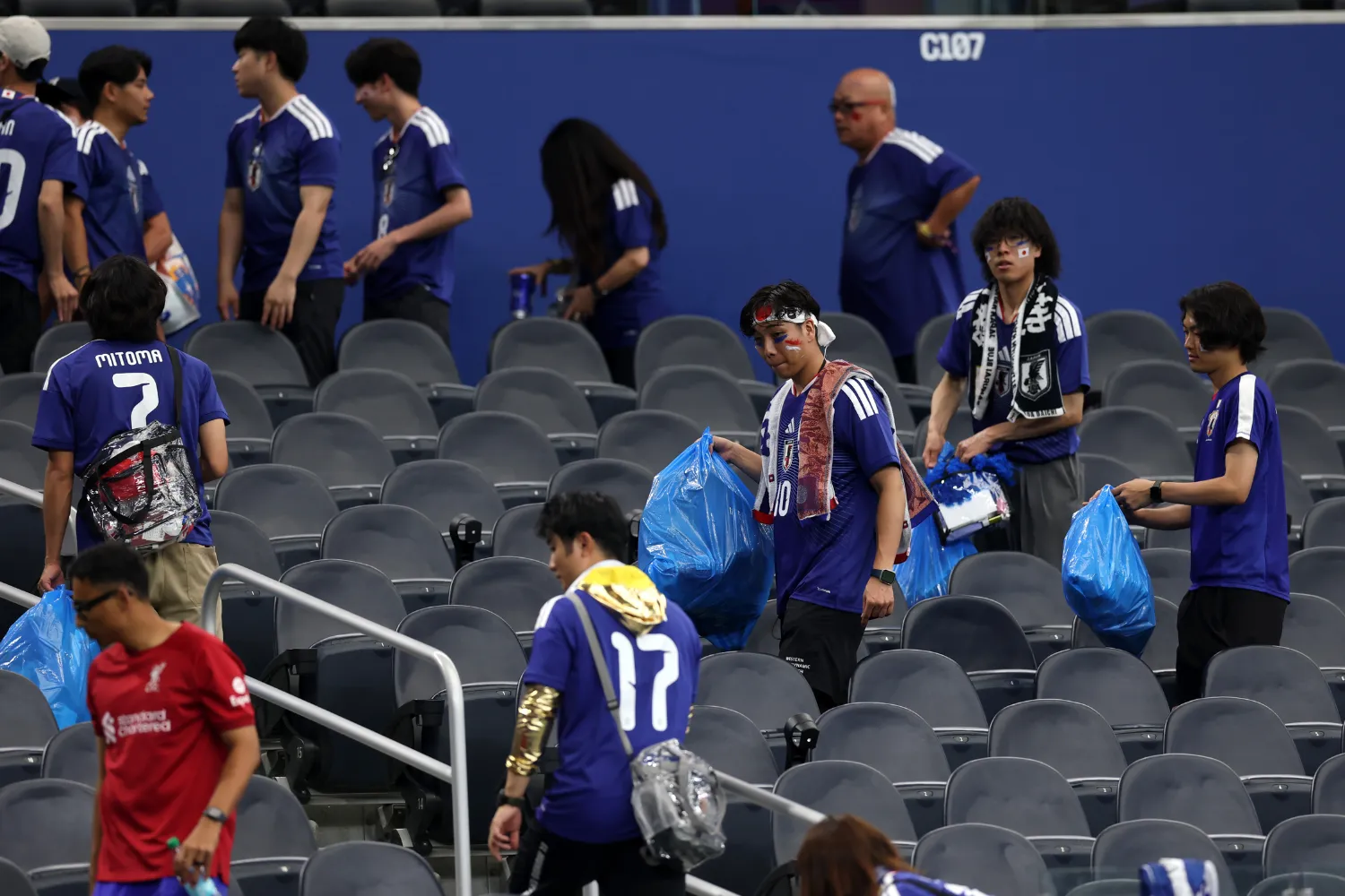 Japan fans clear trash in the stands during the FIFA World Cup 2026 Group F match between Netherlands and Japan at Dallas Stadium on June 14, 2026 in Arlington, Texas.