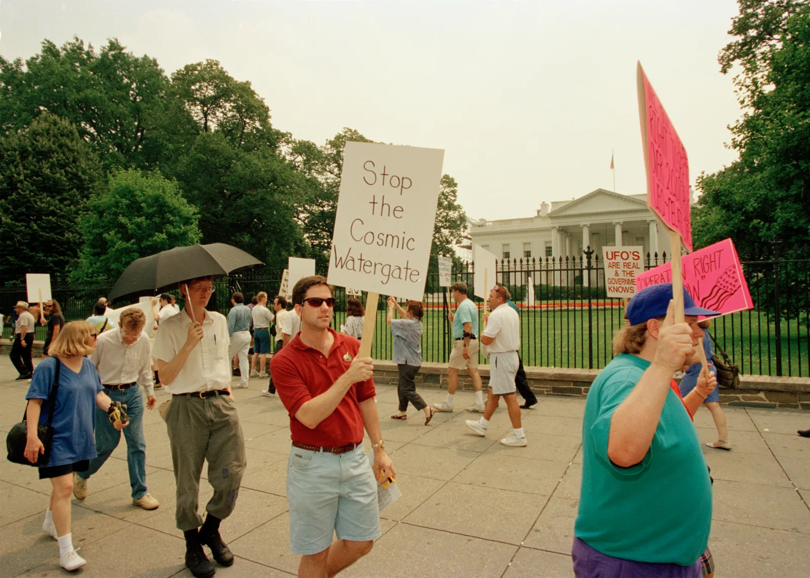 Protesters march in front of the White House in Washington, July 5, 1993, to demand President Clinton make a "full disclosure of government UFO secrets and an open, public inquiry into the phenomena." About 45 people participated in the demonstration. (AP Photo/Joe Marqutte)