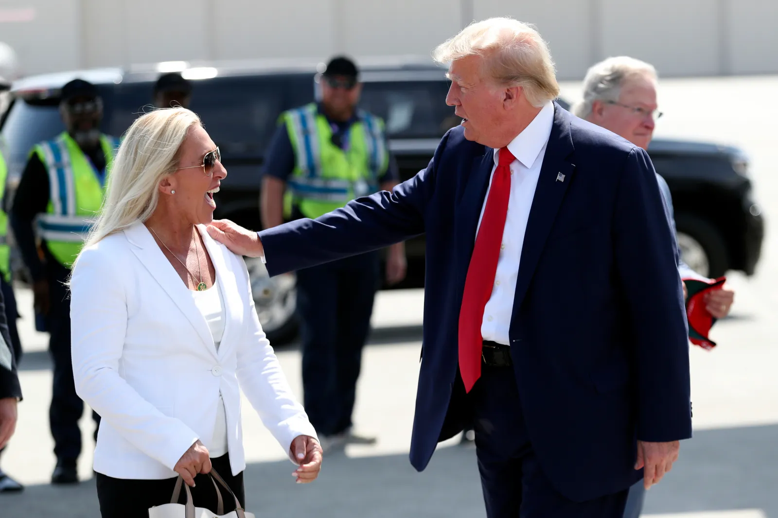 Former President Donald Trump is greeted by Representative Marjorie Taylor Greene as he arrives at Atlantic Aviation CHS in North Charleston, South Carolina, on September 25, 2023. (AP Photo/Artie Walker Jr.)