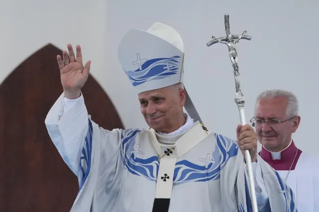 Pope Leo XIV waves to faithful after celebrating Mass in Lampedusa, Sicily, southern Italy, on July 4 during a one-day pastoral visit to the Sicilian island that has come to symbolize the dramatic odyssey of migrants trying to reach Europe by sea.