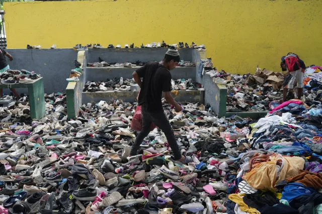 People choose clothes donated to those affected by the earthquakes at a sports complex in La Guaira, Venezuela, on July 4, 2026.