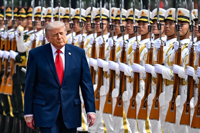 Donald Trump reviews an honor guard with Chinese President Xi Jinping during a welcome ceremony at the Great Hall of the People on May 14, 2026 in Beijing, China.