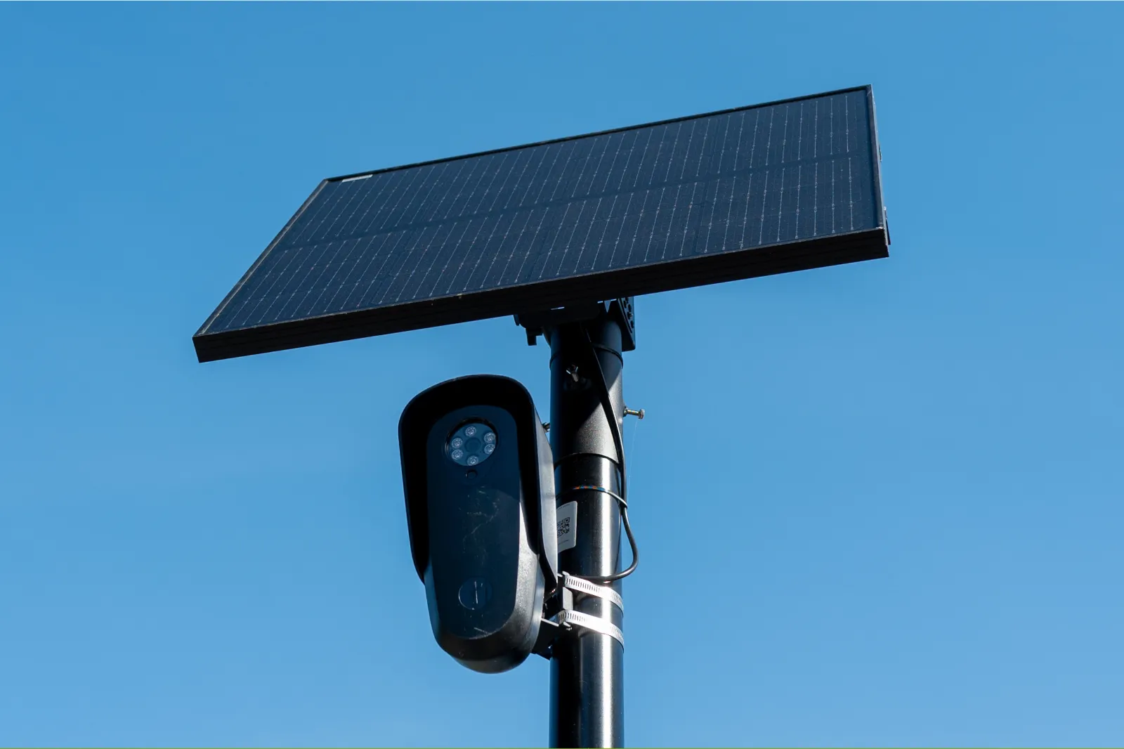 File photo: a Flock license plate reader and camera with solar panel is seen against a blue sky, Pleasant Hill, California, April 16, 2026.