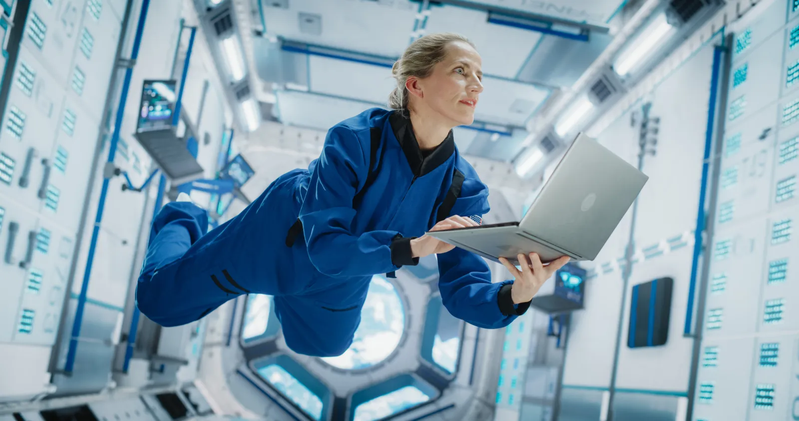 Astronaut floating while using a spacecraft.