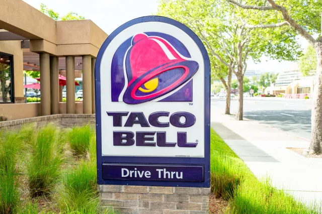 Close-up of Taco Bell sign with drive-thru signage also visible, Walnut Creek, California, April 8, 2025.