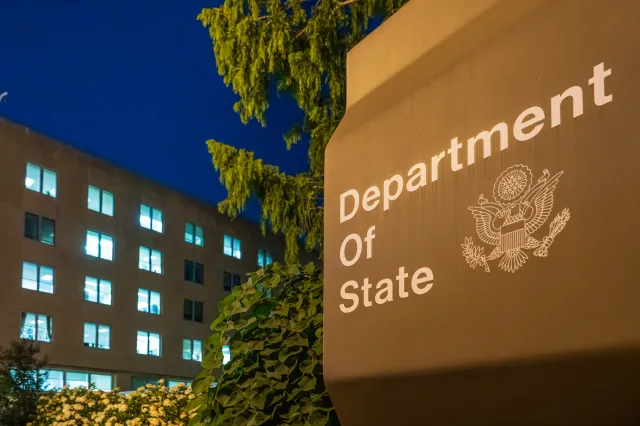 Office lights are illuminated in the U.S. Department of State headquarters building at dusk on July 11, 2025, in Washington, DC. (Photo by J. David Ake/Getty Images)