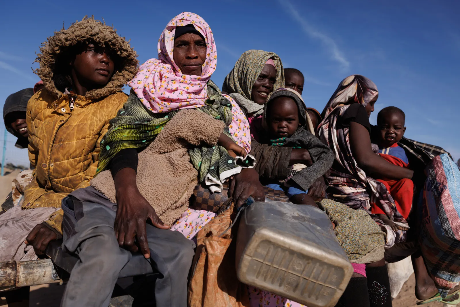 Newly arrived Sudanese refugees prepare to ride back to their temporary shelter after receiving food aid at the Oure Cassoni refugee camp on February 24, 2026 in Oure Cassoni, Chad.