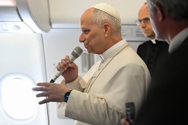 Pope Leo XIV speaks aboard the papal plane flying to Rome on April 23, 2026.