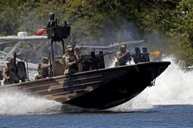 TAMPA, FLORIDA - MAY 20: U.S. Navy Special Warfare Combatant-Craft Crewmen (SWCC) open fire from aboard a Special Operations Craft Riverine (SOC-R) boat during a capabilities demonstration at Special Operations Forces (SOF) Week on May 20, 2026 in Tampa, Florida. Members of the U.S. Special Operations Command (SOCOM), along with special operations soldiers from 10 partner nations, staged a mock hostage rescue utilizing forces on sea, air, and land in Tampa Bay.