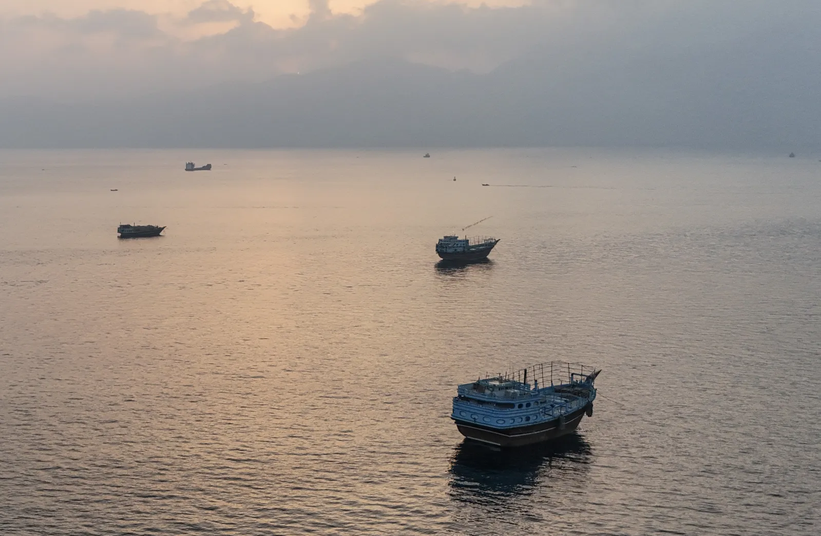 Boats are seen anchored off Oman's northern Musandam Peninsula near the Strait of Hormuz on June 27, 2026.