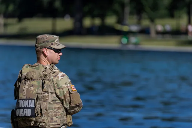 Army National Guard patrols as visitors walk along the Lincoln Memorial Reflecting Pool on the National Mall on June 24, 2026 in Washington, DC.