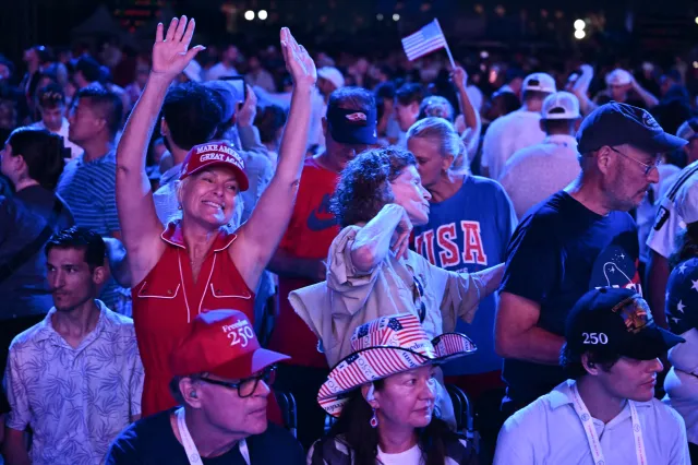 People wait for US President Donald Trump to take the stage to speak during the "Salute to America" Independence Day celebration on the National Mall in Washington, DC, on July 4, 2026.