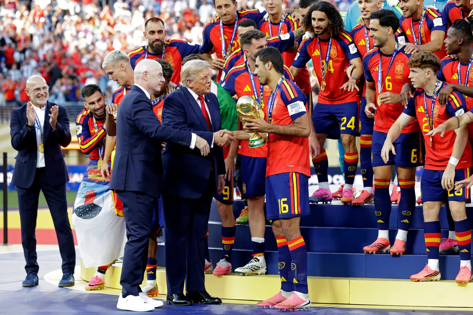 EAST RUTHERFORD, UNITED STATES - JULY 19: Unai Simon of Spain, Pedro Porro of Spain, Pau Cubarsi of Spain, Aymeric Laporte of Spain, Marc Cucurella of Spain, Rodri of Spain, Fabian Ruiz of Spain, Lamine Yamal of Spain, Dani Olmo of Spain, Alex Baena of Spain, Mikel Oyarzabal of Spain, Pedri of Spain, Ferran Torres of Spain, Mikel Merino of Spain, Nico Williams of Spain, Eric Garcia of Spain, Martin Zubimendi of Spain, David Raya of Spain, Joan Garcia of Spain, Marcos Llorente of Spain, Marc Pubill of Spain, Alex Grimaldo of Spain, Gavi of Spain, Yeremy Pino of Spain, Borja Iglesias of Spain, Victor Munoz of Spain, coach Luis de la Fuente of Spain celebrating the world cup victory with the trophy with the attendance of US President Donald Trump, Gianni Infantino President of FIFA during the World Cup match between Spain v Argentina at the New York New Jersey Stadium on July 19, 2026 in East Rutherford United States (Photo by Eric Verhoeven/Soccrates/Getty Images)