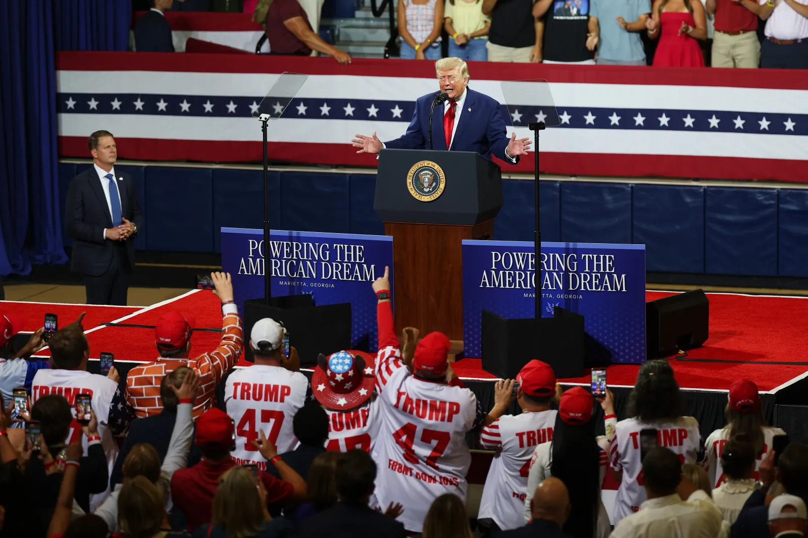Supporters cheer as President Donald Trump speaks at Wheeler High School in Marietta, Georgia, on July 22, 2026.