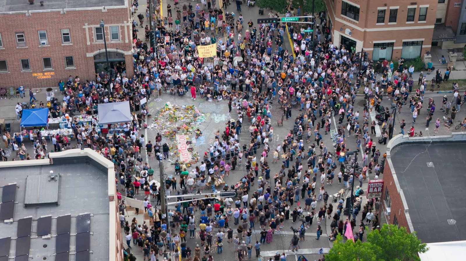 In an aerial view, people attend a vigil at the intersection where Corey Ruiz was shot and killed by a Madison Police officer on July 23, 2026, in Madison, Wisconsin. (Photo by Scott Olson/Getty Images)