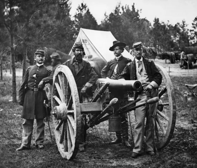Four Union artillery officers are pictured with a cannon in the vicinity of Fair Oaks, Virginia, on June 1862.