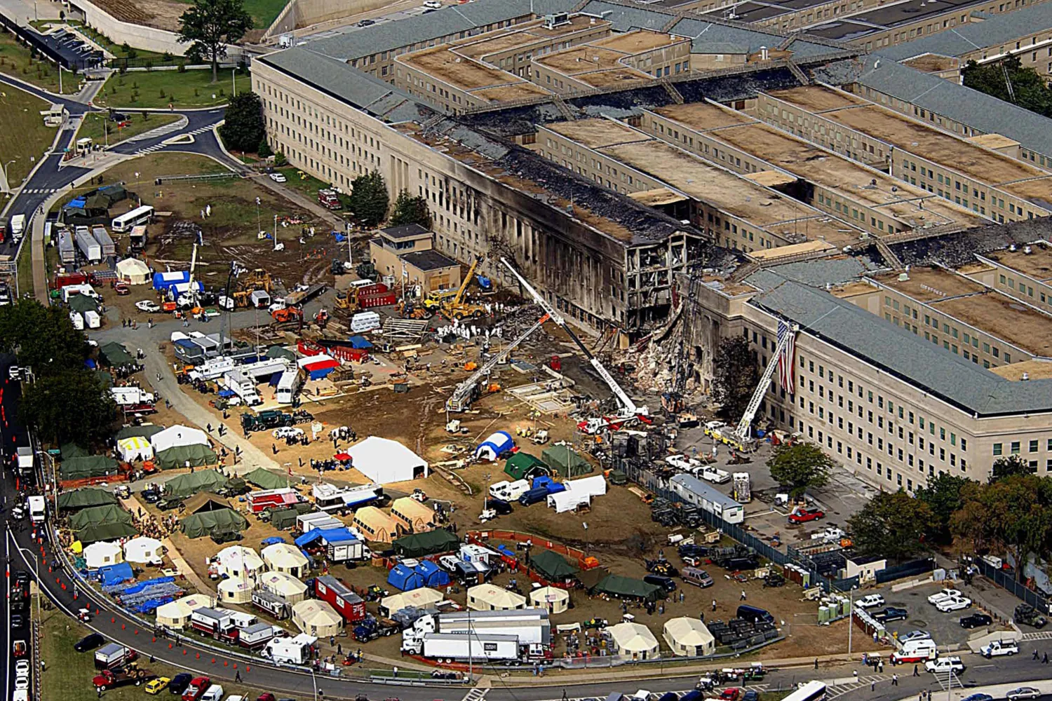 This 14 September 2001 image shows FBI agents, fire fighters, rescue workers and engineers work at the Pentagon crash site in Washington, DC, where a high-jacked American Airlines flight slammed into the building 11 September 2001. The terrorist attack caused extensive damage to the west face of the building and followed similar attacks on the twin towers of the World Trade Center in New York City.
