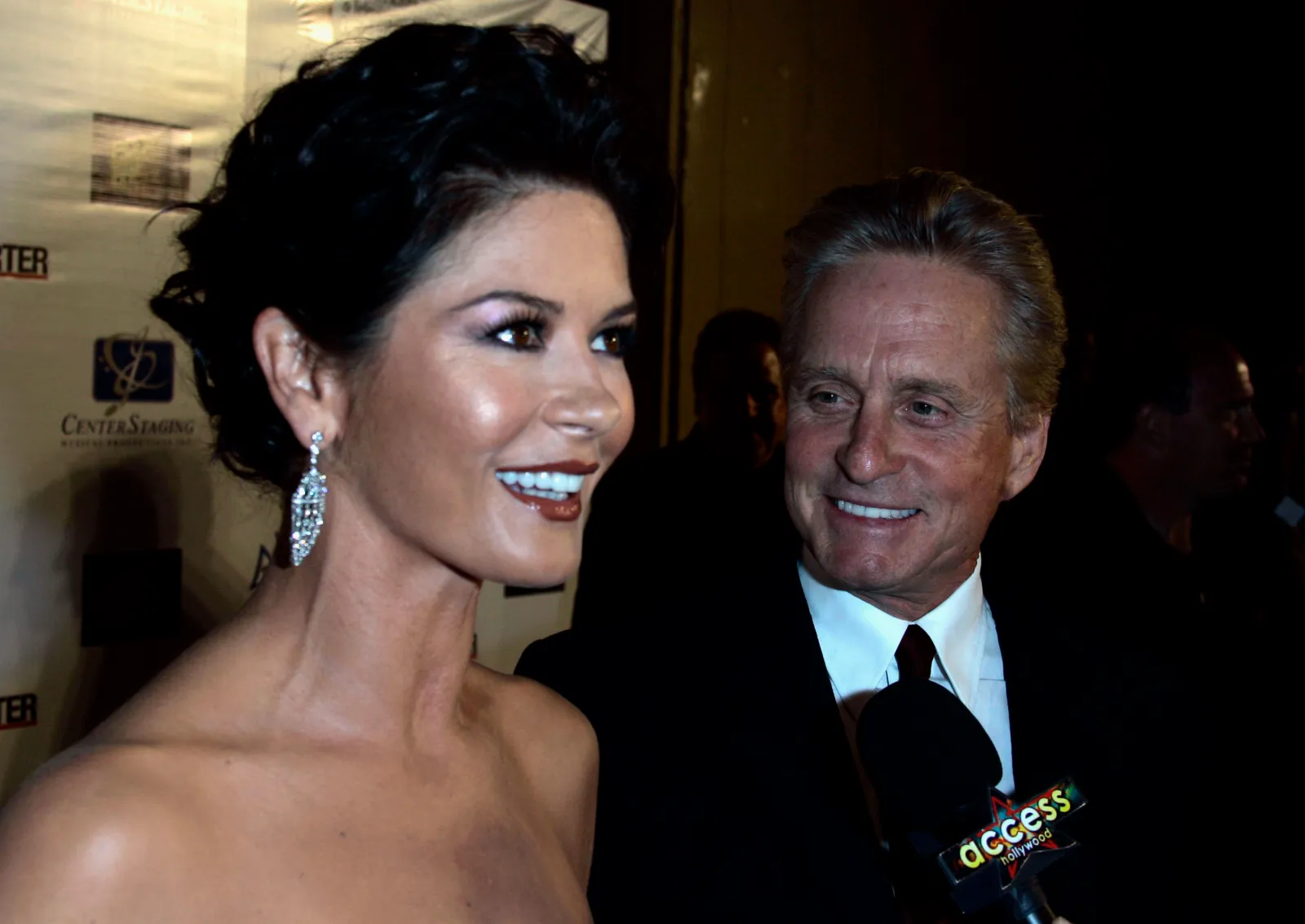 Actors Catherine Zeta-Jones, left, and Michael Douglas are interviewed by members of the media as they arrive at "A Fine Romance" third annual benefit at Sony Pictures in Culver City, Calif., Saturday, Oct. 20, 2007.