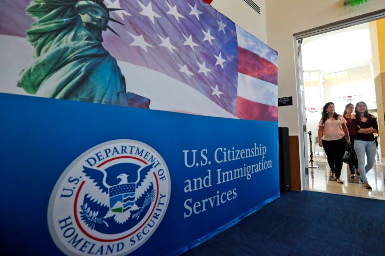 People arrive before the start of a naturalization ceremony at the U.S. Citizenship and Immigration Services Miami Field Office in Miami. | AP Photo/Wilfredo Lee