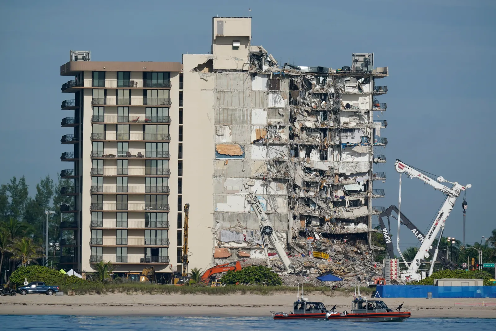 Coast Guard boats patrol in front of the partially collapsed Champlain Towers South condo building in Surfside, Florida, on July 1, 2021. (AP Photo/Mark Humphrey, File)