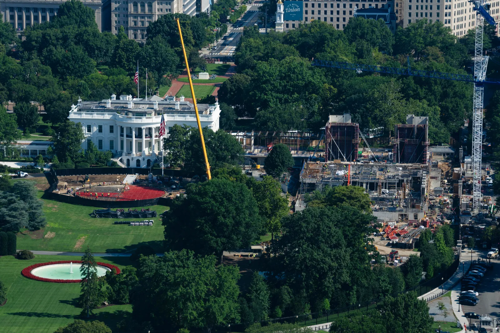 Construction continues on the White House helipad, left, and ballroom, right, Friday, Aug. 7, 2026, in Washington. (AP Photo/Allison Robbert)