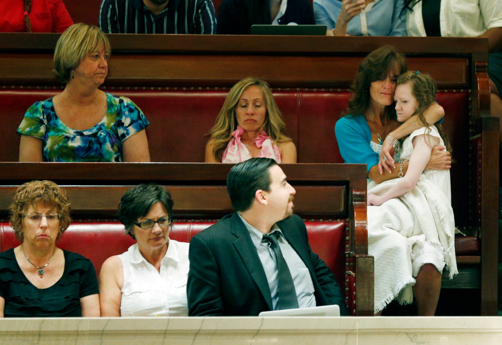 Kathy Annable of Marcellus, N.Y., right, holds her daughter Kaylie, 11, in the Senate gallery as senators debate the medical marijuana bill at the Capitol on Friday, June 20, 2014, in Albany, N.Y. The Senate passed the bill making New York the 23rd state to legalize, but the drug won