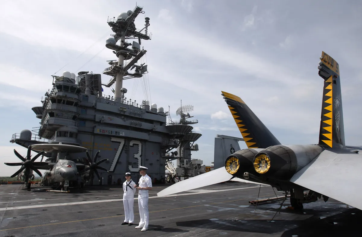 U.S. Navy sailors stand guard on the deck of USS George Washington in Port Klang, Malaysia, on October 7, 2012.