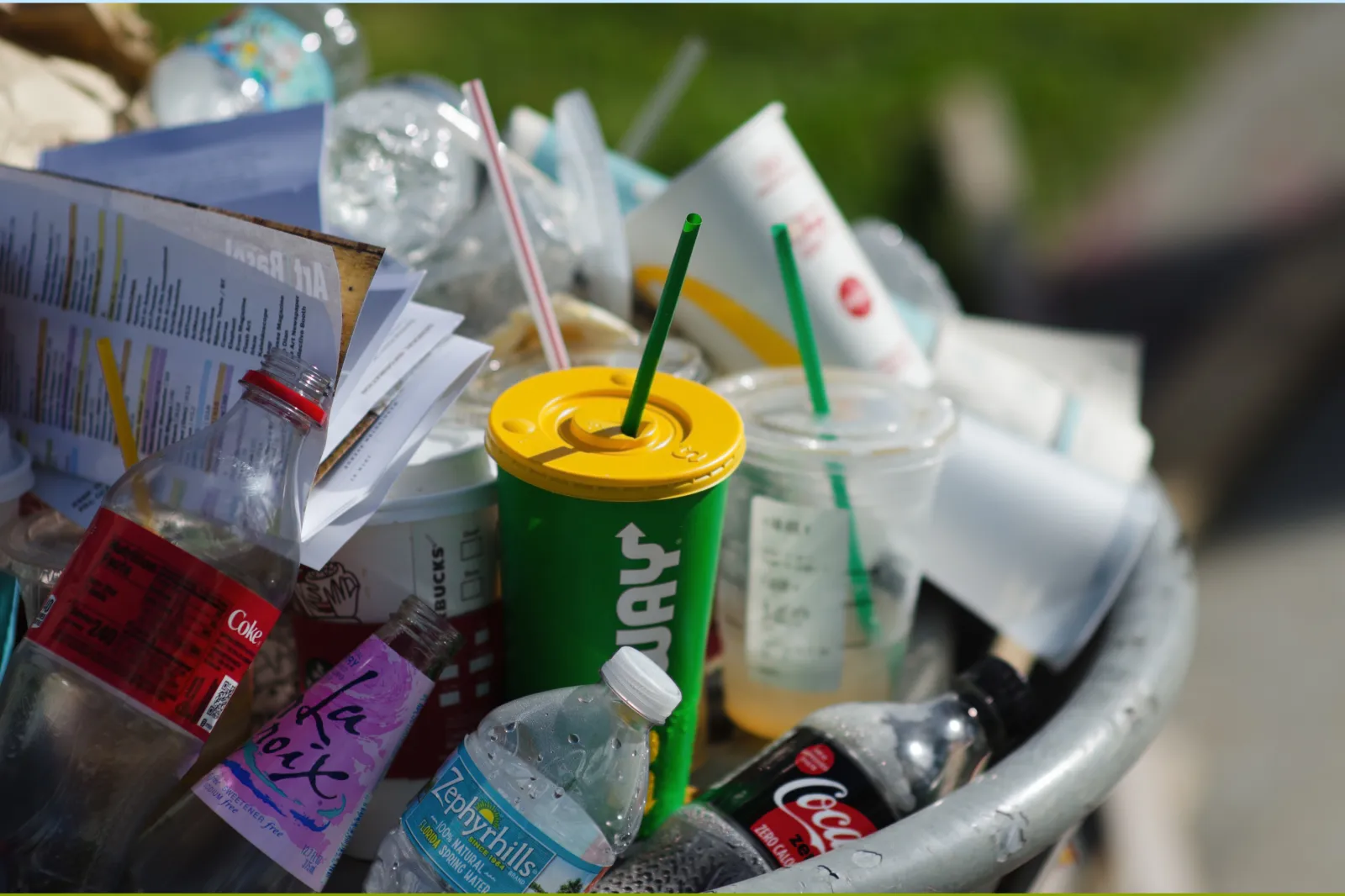  Consumer trash from fast-food chains, drinks brands, and plastic water bottles overflows from a public garbage can on the street outside Art Basel Miami Beach.