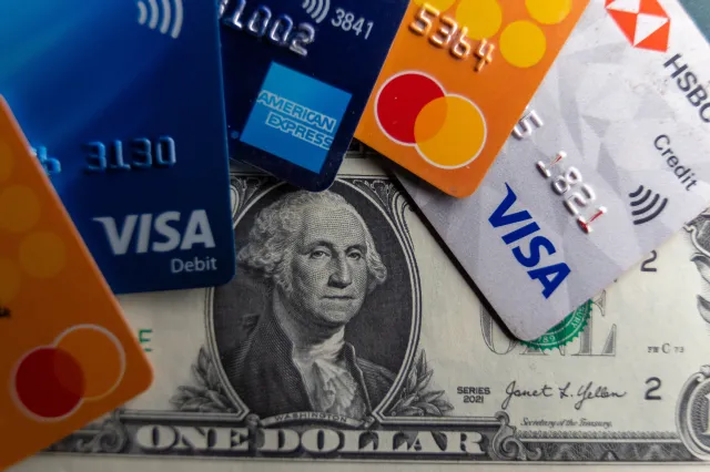 Various src cards and debit cards are seen beside US one dollar bills on February 4, 2025
