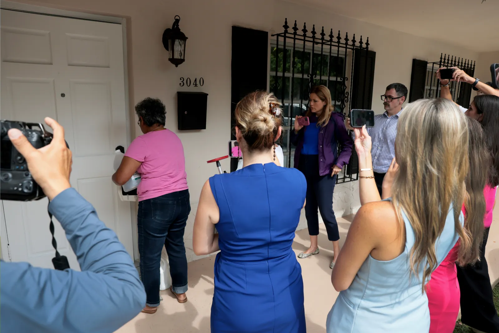 Members of the media crowd around the front door as people enter the home where Perez Hilton was found after he appeared to harm himself during a TikTok livestream on August 05, 2026 in Westchester, Florida.