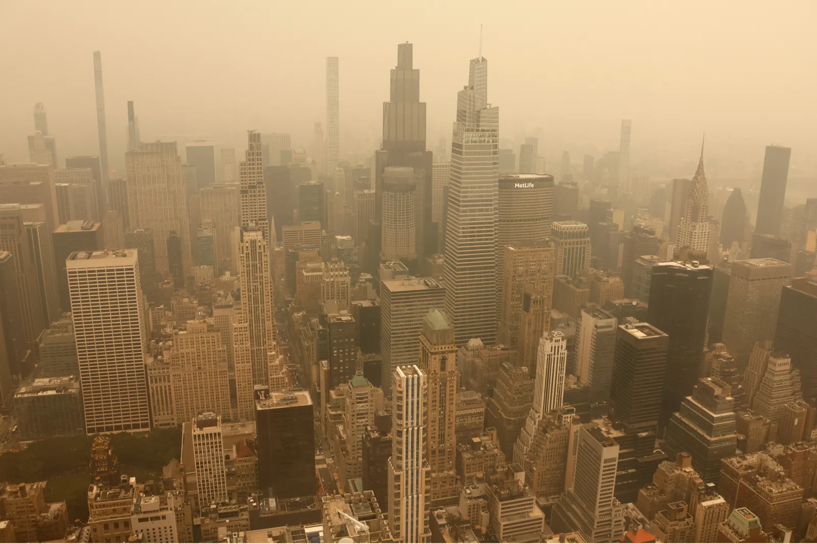 Smoke from wildfires in Canada shrouds the view north to midtown Manhattan, seen from the 86th-floor observation deck of the Empire State Building before sunset on July 15, 2026, in New York City.