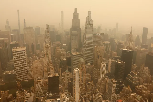 Smoke from wildfires in Canada shrouds the view north to midtown Manhattan, seen from the 86th-floor observation deck of the Empire State Building before sunset on July 15, 2026, in New York City.