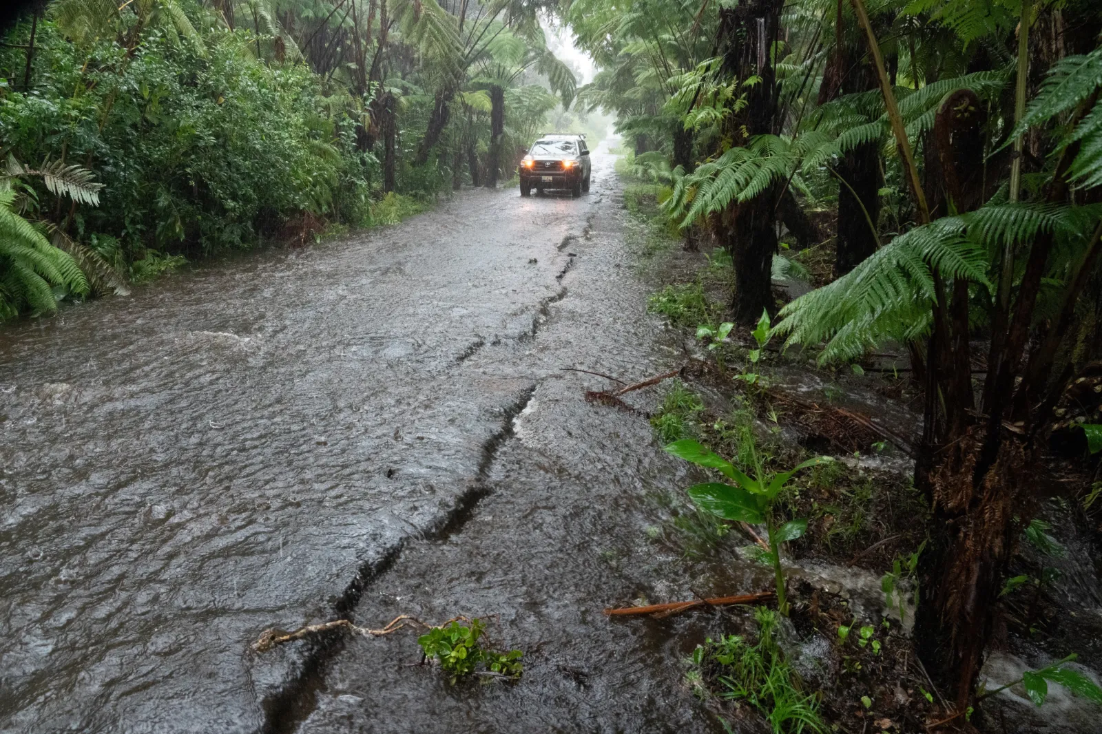 A rural road floods in Volcano Village on Hawaii Island, on August 15, 2026.