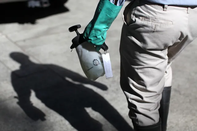 Mosquito and Vector Control District technician carries a container of BVA Larvacide Oil on June 29, 2012 in Pleasant Hill, California, as reports of mosquitoes with West Nile virus increase.