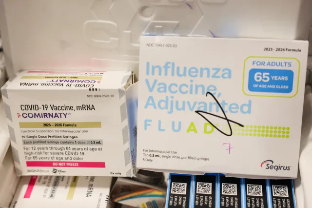 File photo: boxes of the Pfizer-BioNTech COVID-19 vaccine and Seqirus Fluad adjuvanted flu shot lie in Los Angeles, October 24, 2025.